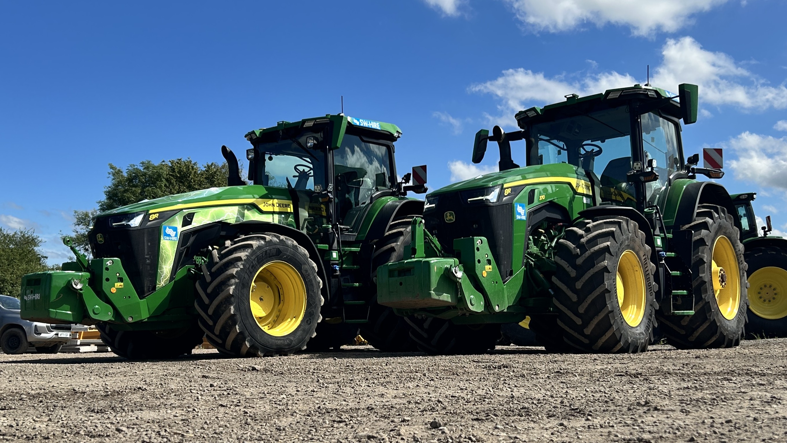 John Deere 8R370 and 8R410 in a yard